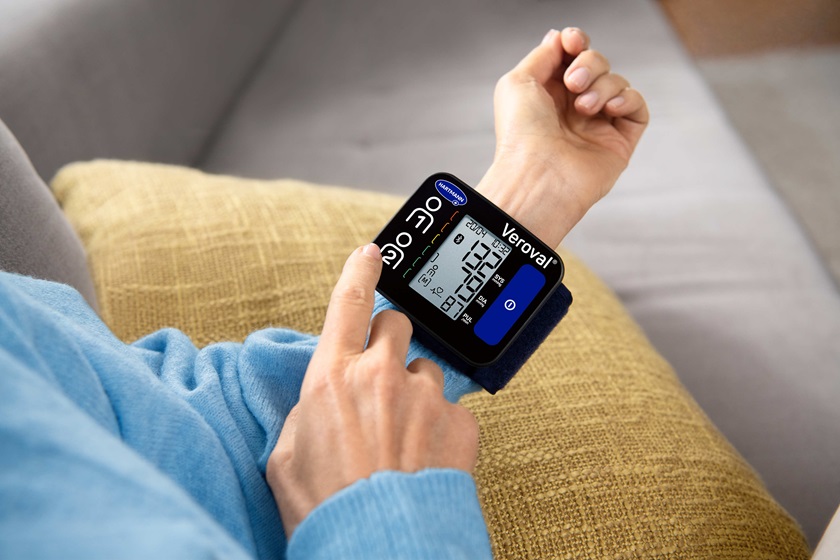 Veroval compact wrist blood pressure monitor in use closeup